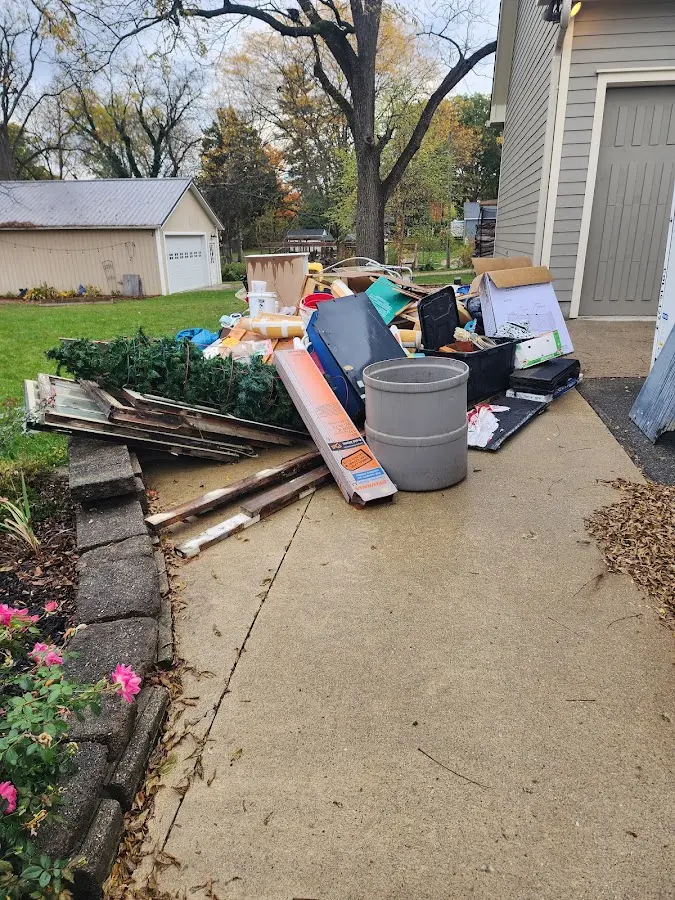 Dumpster being loaded with debris for Residential Dumpster Rental in Deerfield